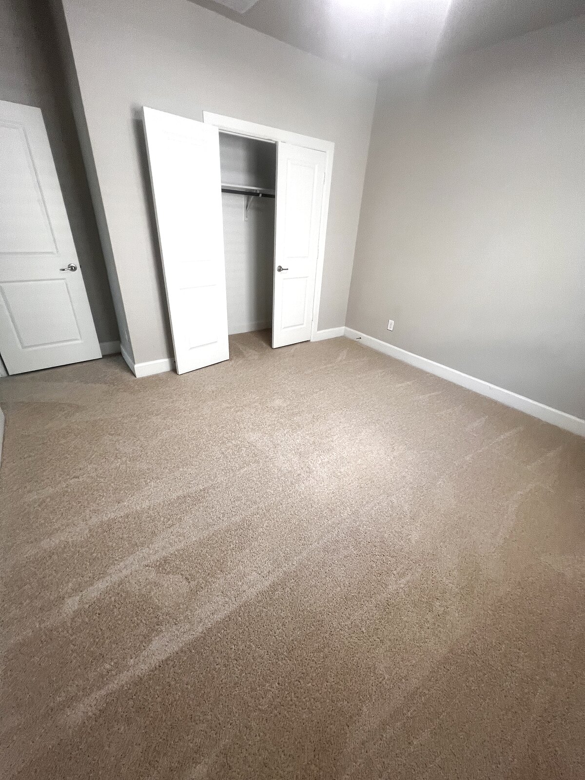 Freshly carpeted bedroom with walk-in closet