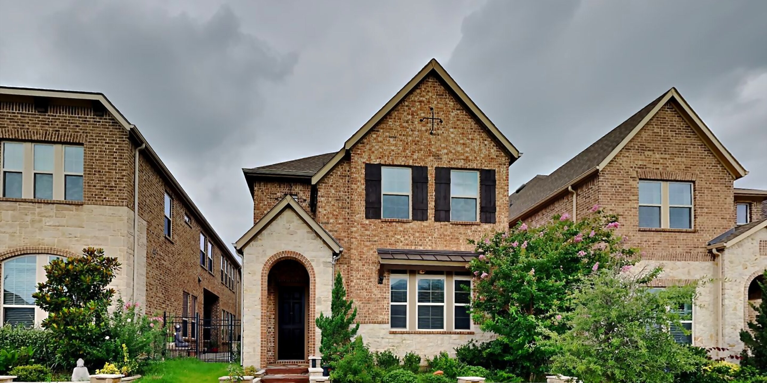 Front elevation of 6761 E Prospect Way, a brick-and-stone two-story home in Irving, Texas